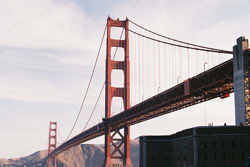 bridge red and black bridge during daytime building